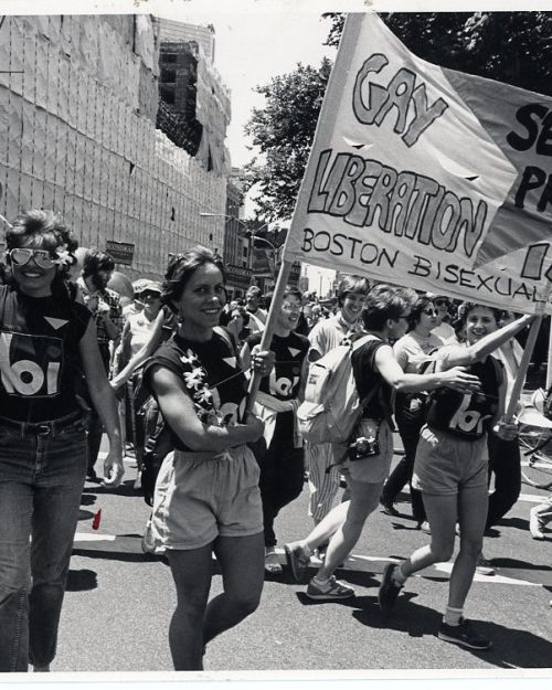 The Boston Bisexual Women’s Network is a feminist, not-for-profit collective organization whose purpose is to bring women together for support and validation. This photograph shows women in a parade carrying a banner which reads: "Bisexual Pride, Gay Liberation Is Our Liberation, Boston Bisexual Women's Network". Credit: Susan Fleischmann