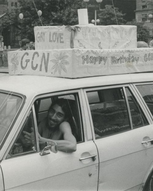 Photo shows GCN [Gay Community News] Office Manager Ron Arruda driving the birthday cake in the 1974 parade.