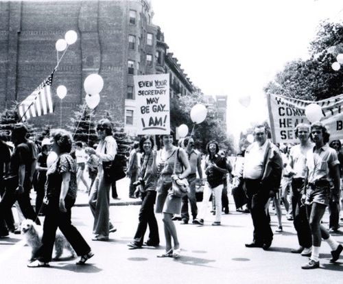 Marchers at Gay Pride, Boston, 1974. One holding a sign that reads "Even your secretary may be gay... I am!" Credit: Pat Donoghue