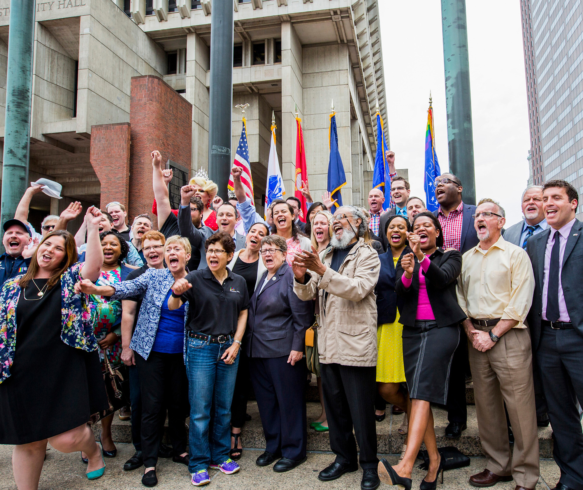 Members of the Boston Pride Committee and City Officials cheer after the raising of the rainbow flag at Boston City Hall Plaza on June 3, 12016.